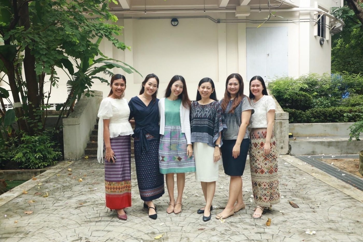 Kru Ice with fellow teachers wearing traditional Thai fabric skirts